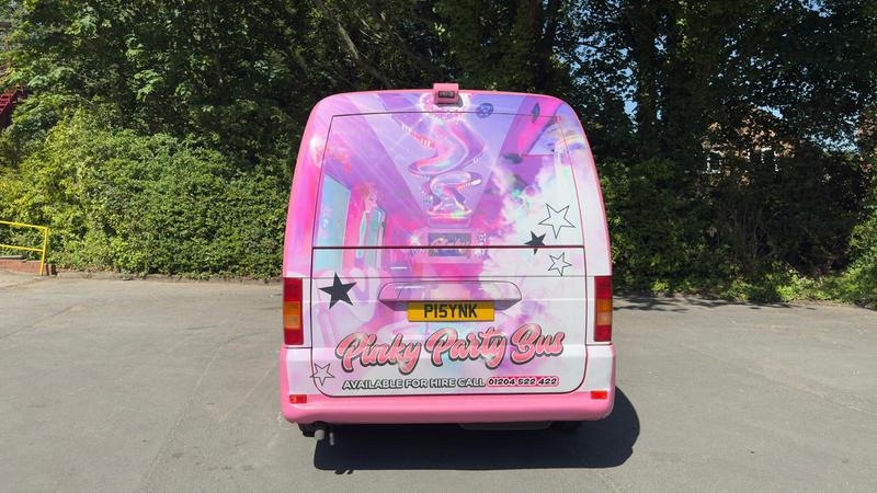 Pink party bus rear exterior - luxury group transport